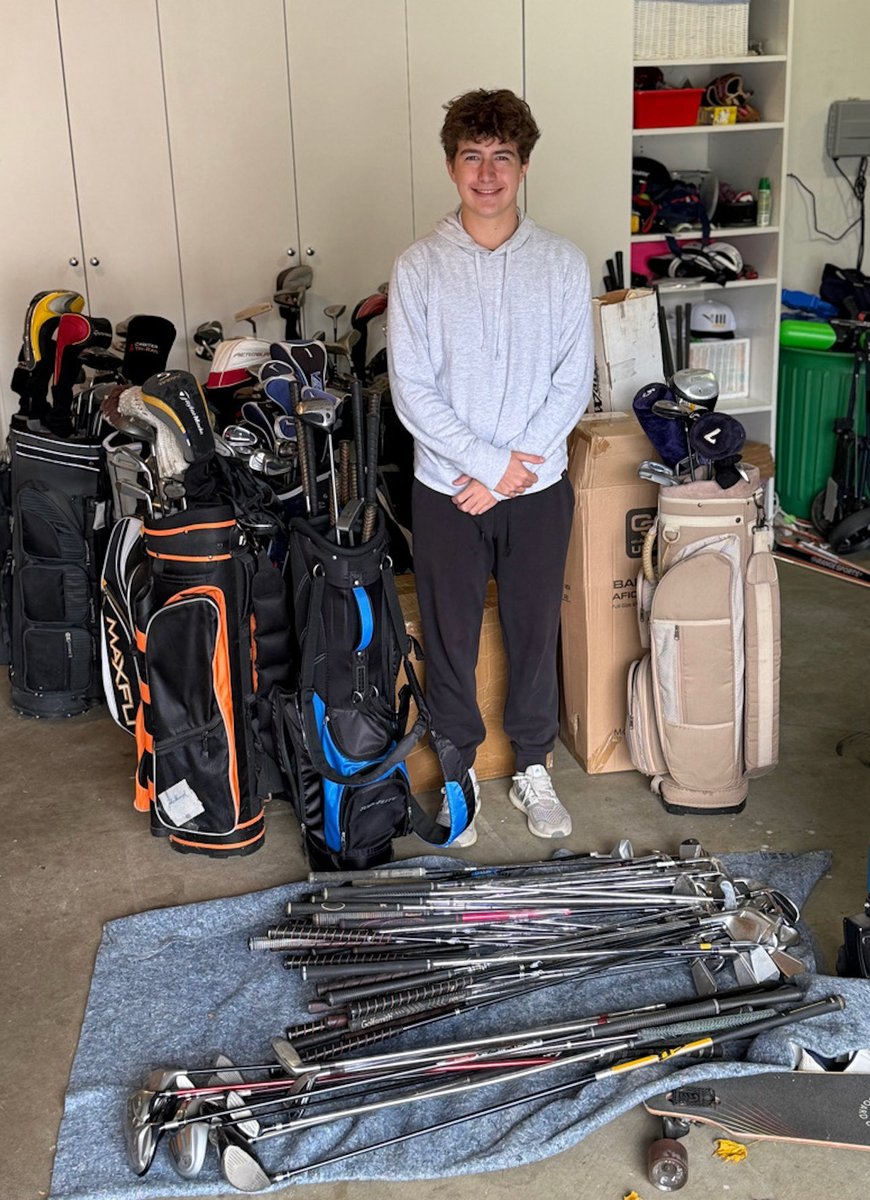 Grant Stastney with donated golf bags and clubs